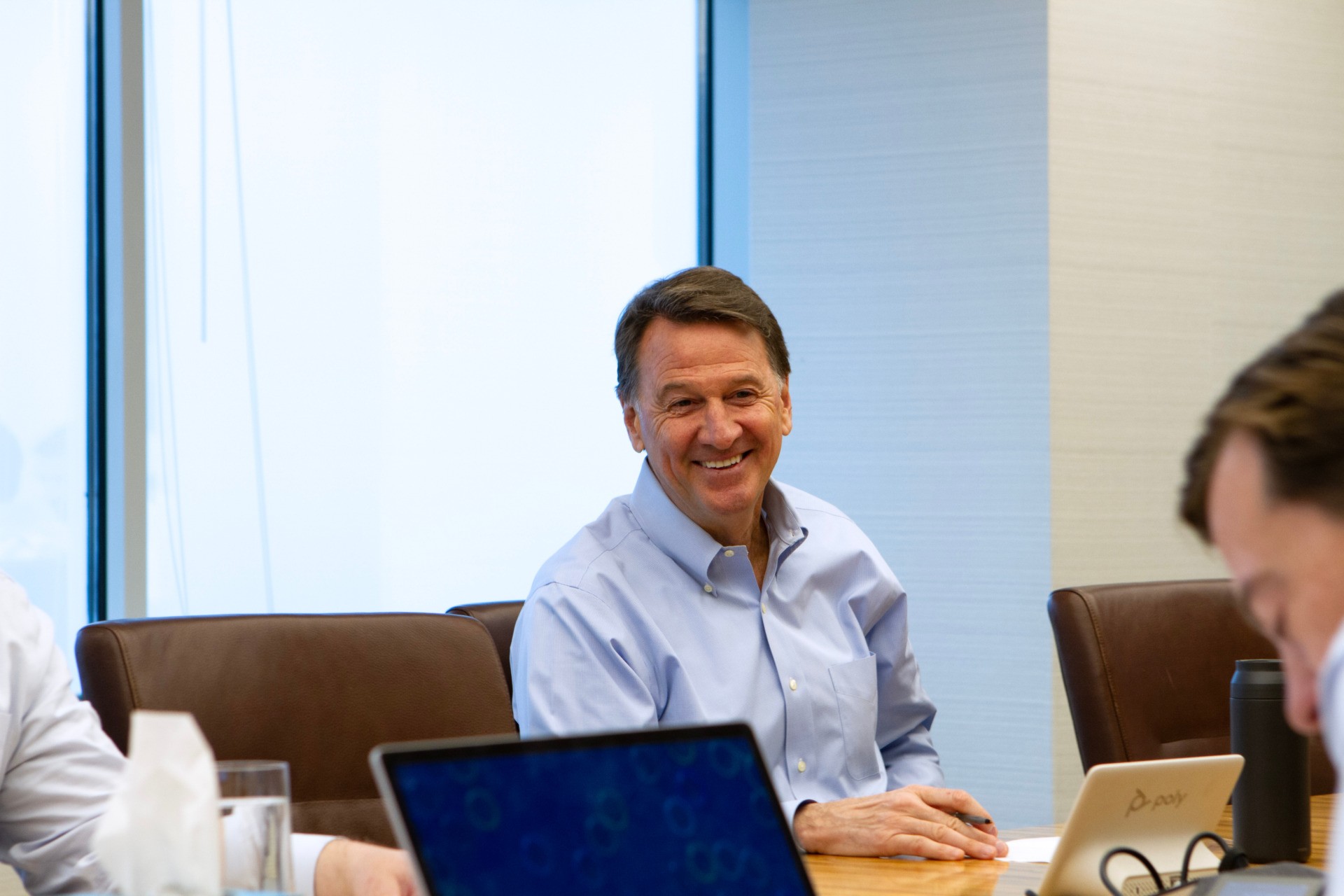 Rooted in growth. Powered by people. Westfield's CEO Will Muggia engaged in a meeting in the board room.