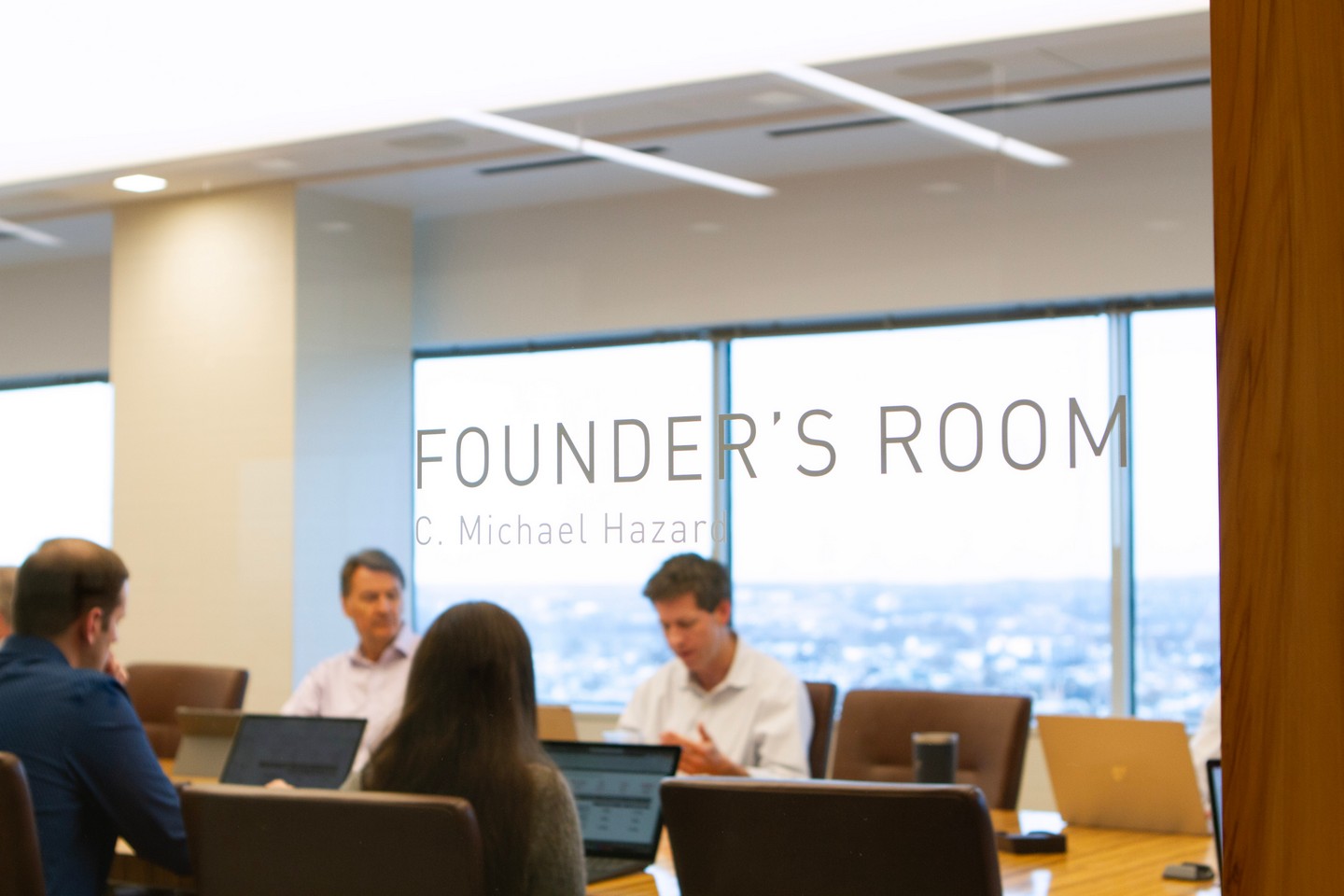Our Approach. Investment Committee meeting in the Westfield board room, the name "Founder's Room" is etched on the glass.