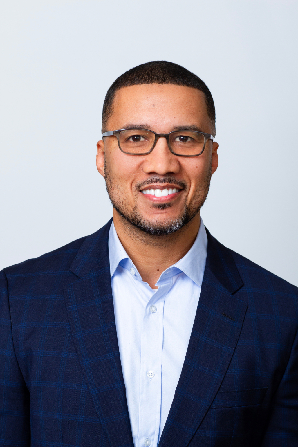 Rooted in growth. Powered by people. Headshot of Dee Silveira Partner, Chief Technology Officer. He is wearing glasses, a navy blazer, and a light blue collared shirt.