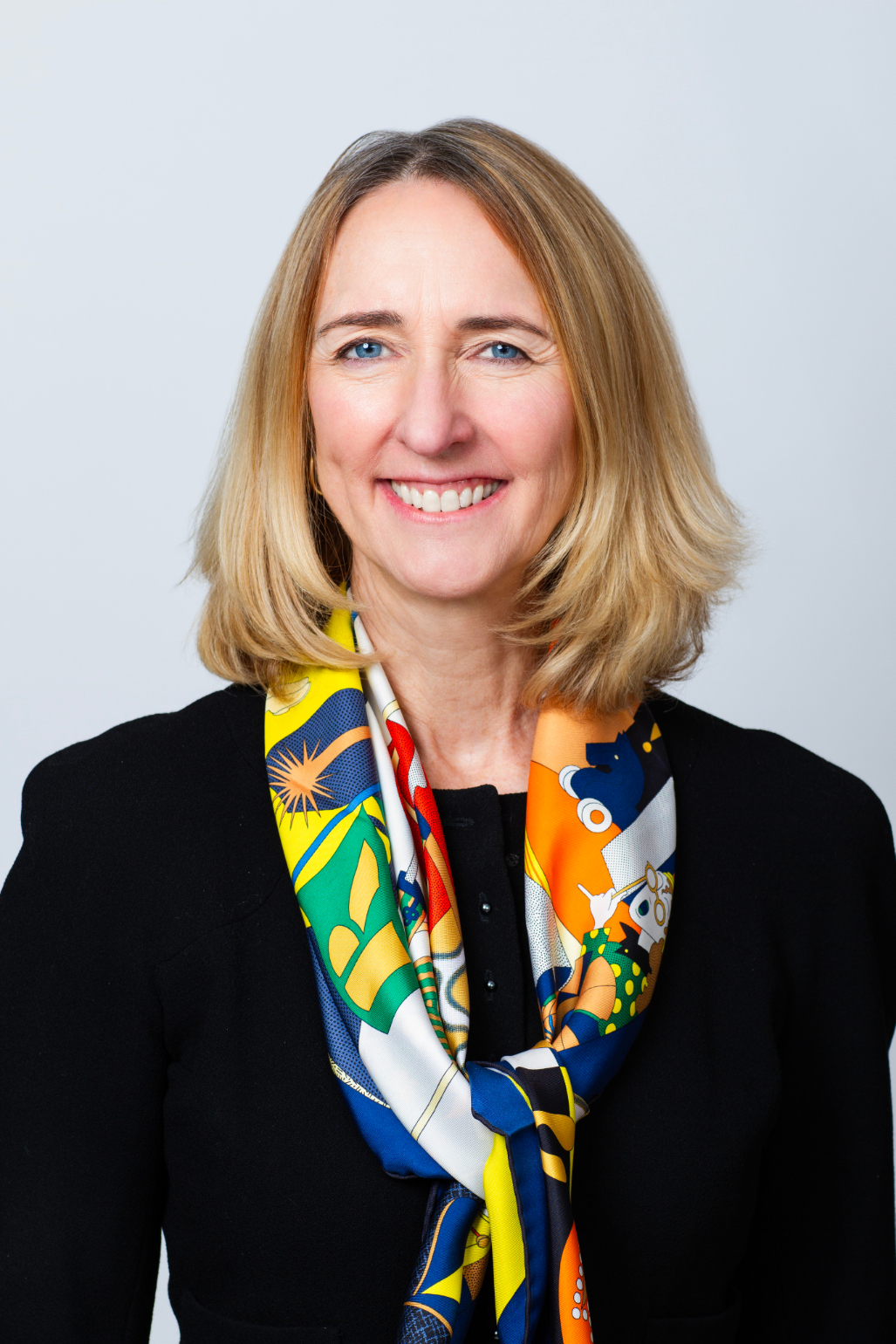 Rooted in growth. Powered by people. Headshot of Westfield's Partner, Chief Financial Officer & Chief Compliance Officer, Katie Kearney. She has short, blonde hair and is dressed in a black blazer with a colorful scarf tied around her neck.
