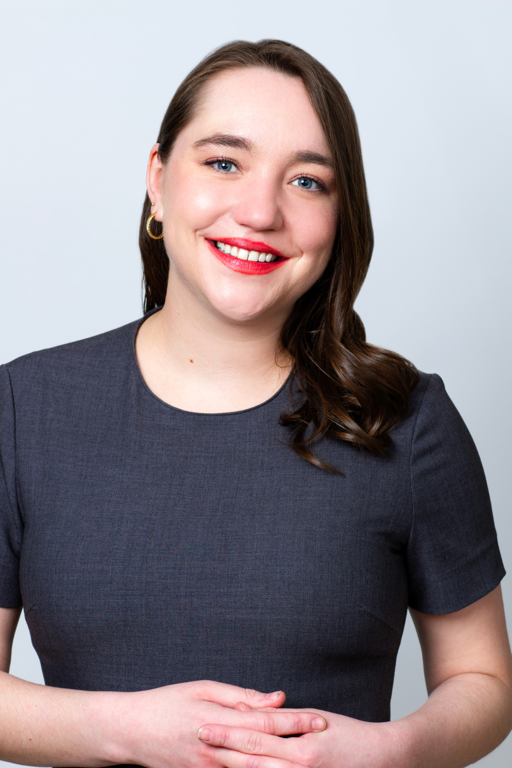 Rooted in growth. Powered by people. Headshot of Mary Lyons, Human Resources Manager. She is wearing a dark grey, short sleeve top.