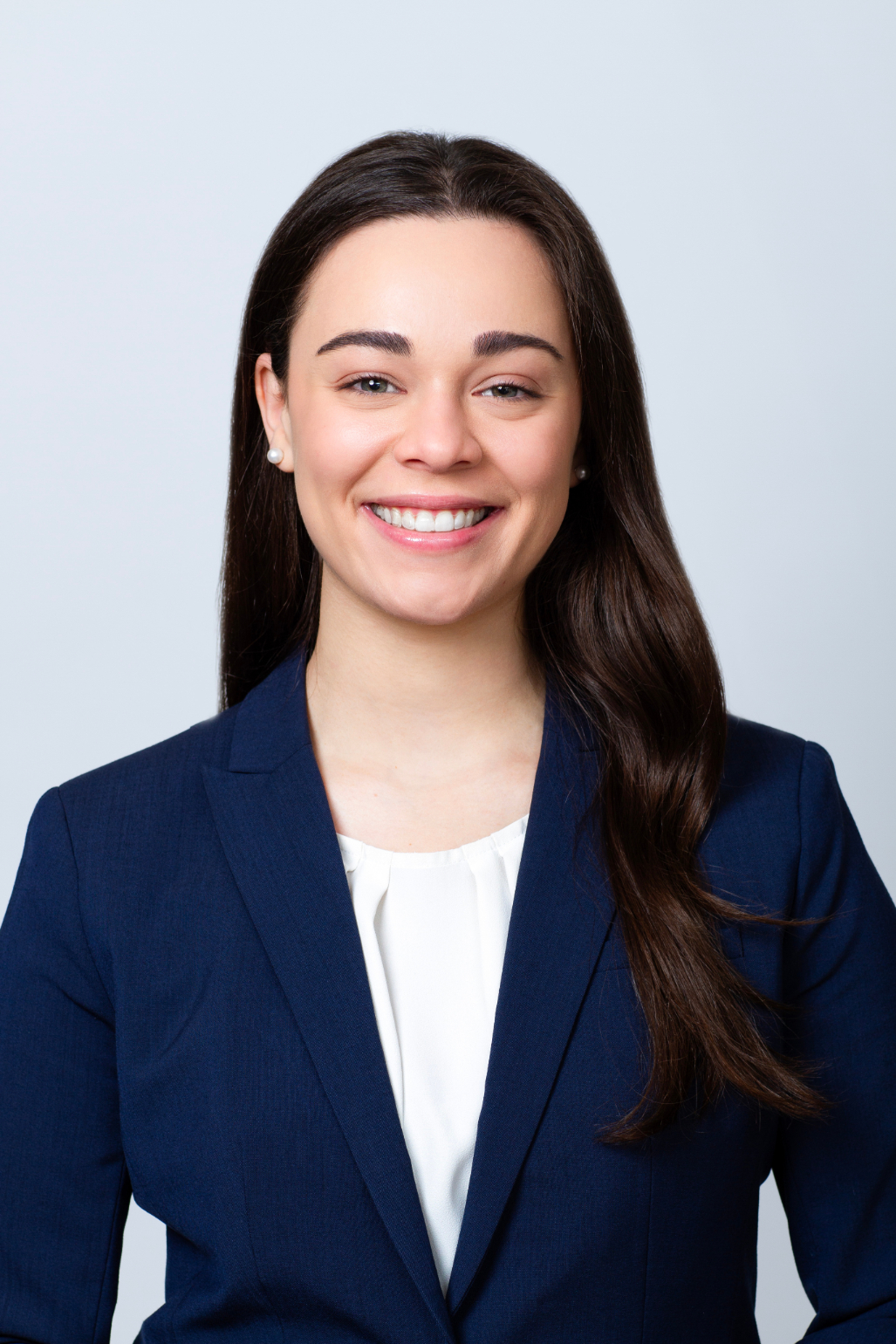 Marissa Guzzo Research Analyst professional headshot. She is wearing a white shirt with a navy blazer.
