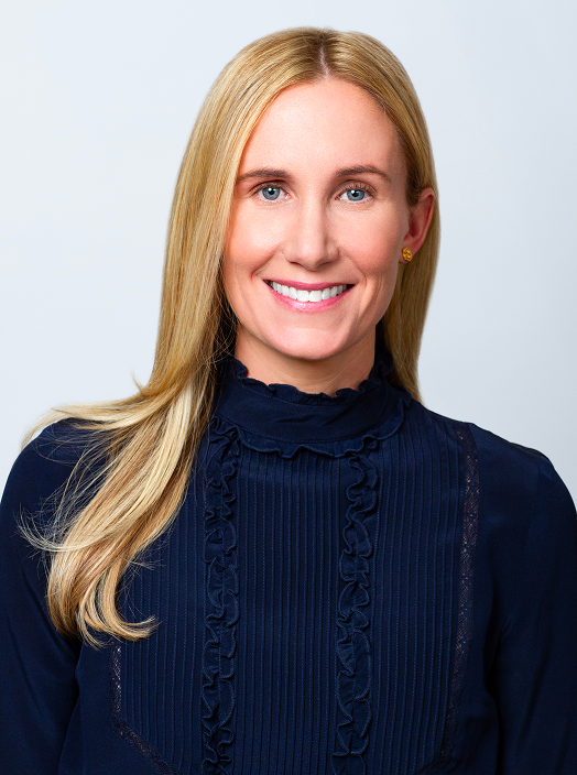 Jenny Muller CFA Director of Marketing professional headshot. Jenny is wearing a navy turtleneck blouse.