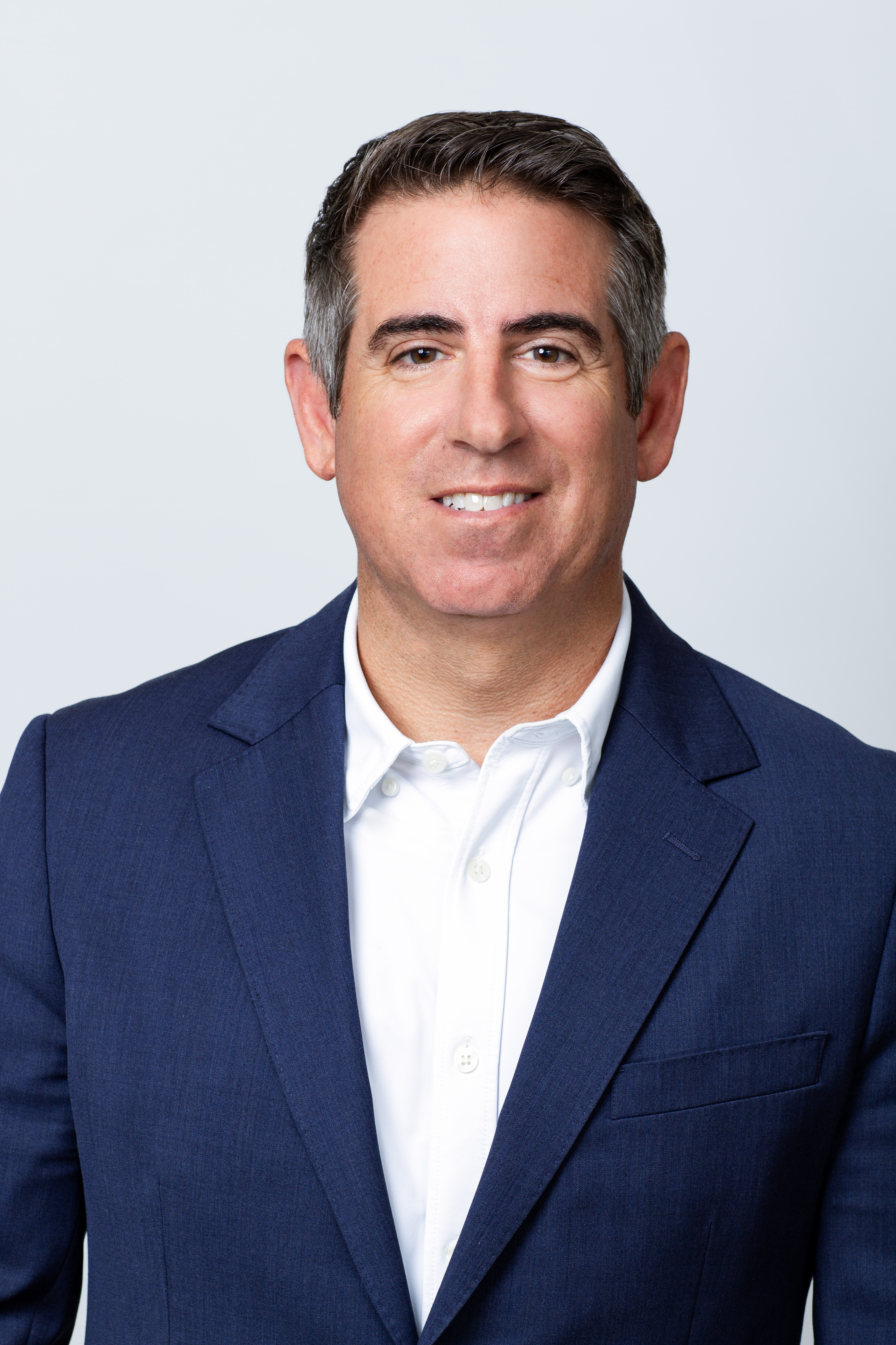 Matt Renna Managing Partner professional headshot. He is wearing a navy blazer and a white button-down shirt.