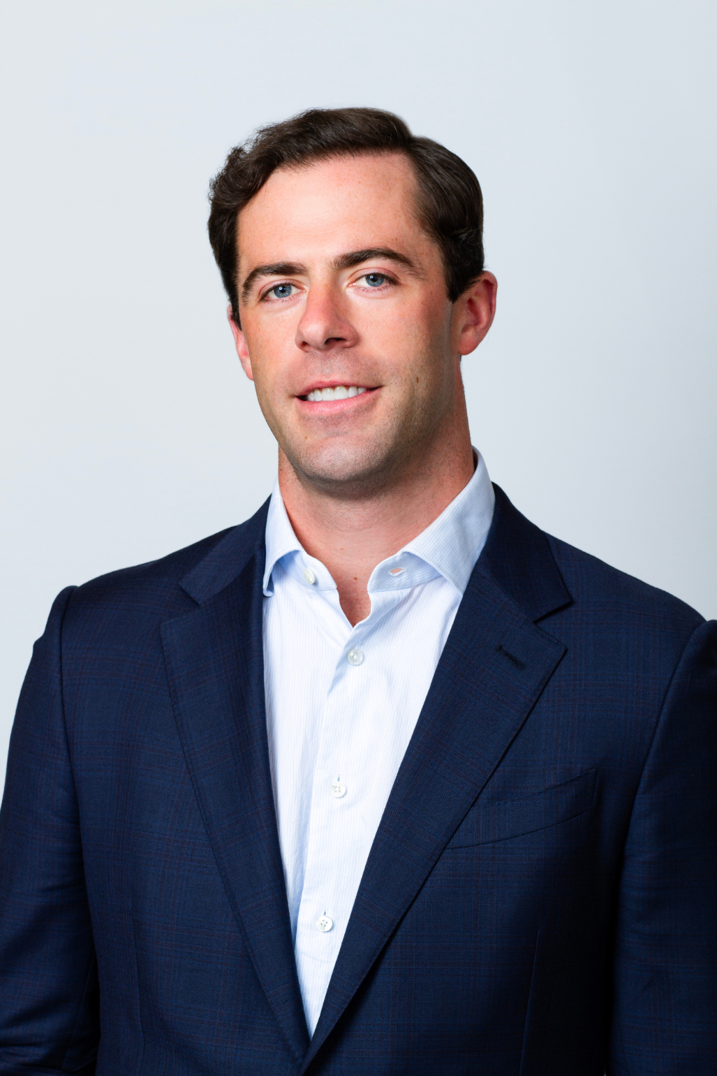 Joe Kearney Senior Security Analyst professional headshot. He is wearing a white button-down shirt with a navy blazer.