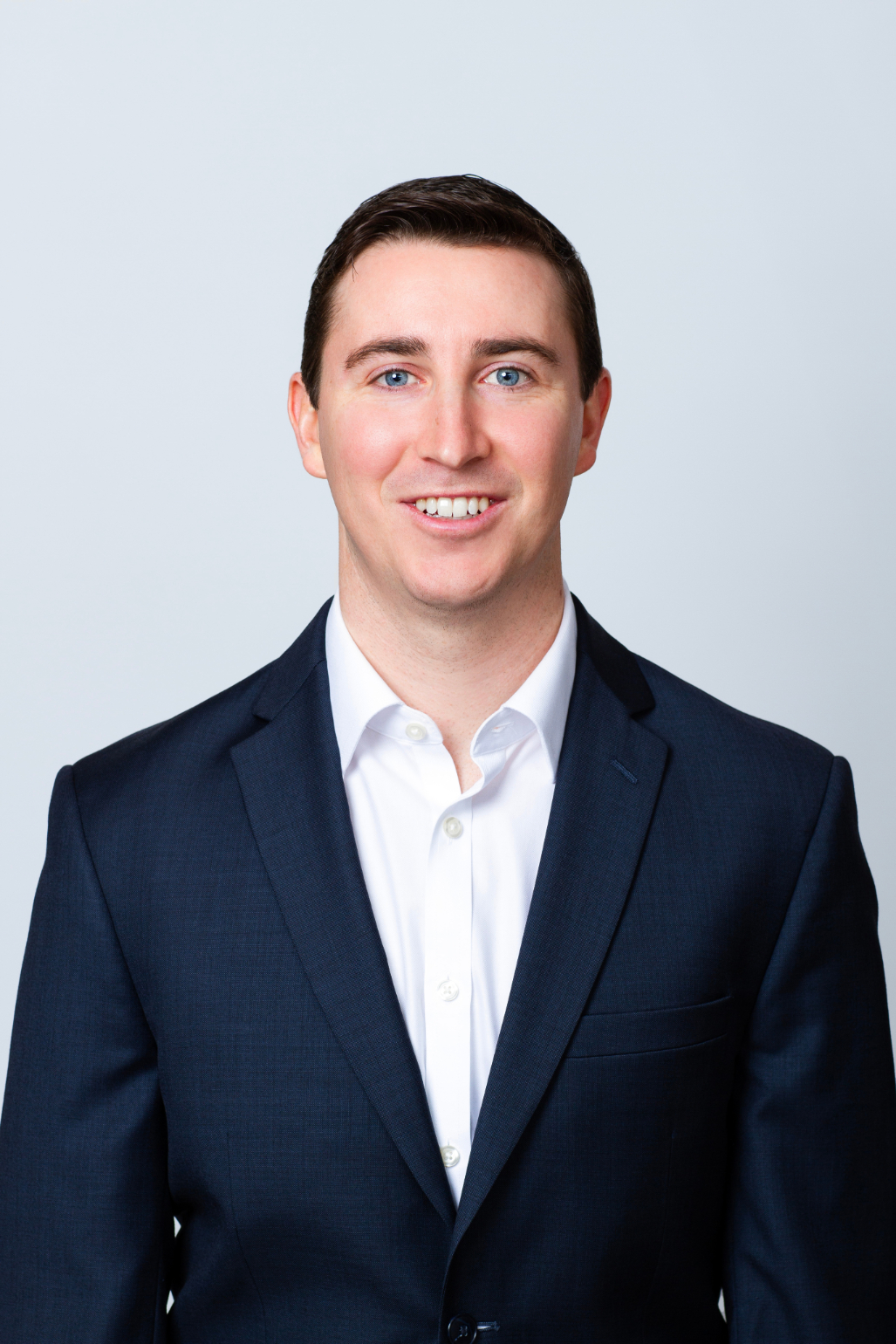 Rooted in growth. Powered by people. Headshot of Matthew Villano, Trading Associate. He is wearing a white collared shirt with a navy blazer over it.